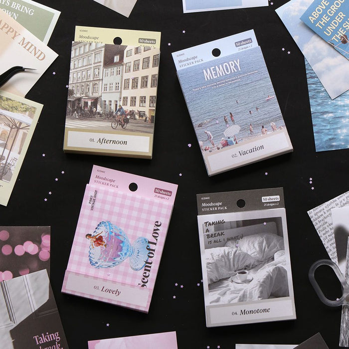 The Journal Shop - Collection of Iconic Moodscape Background Sticker packs in various colours and themes arranged on a black surface.