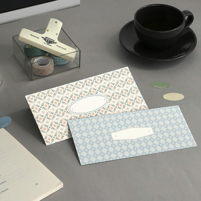 The Journal Shop - Blue and cream patterned Iconic Pattern Envelopes arranged beside a teacup and stationery accessories.