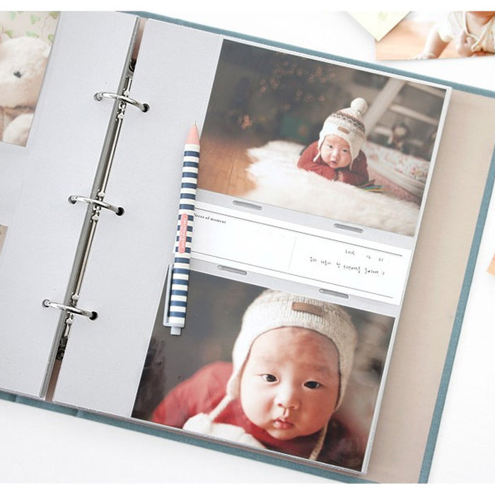 The Journal Shop - Memory binder with photographs of a child placed in transparent sleeves on a clean white background.