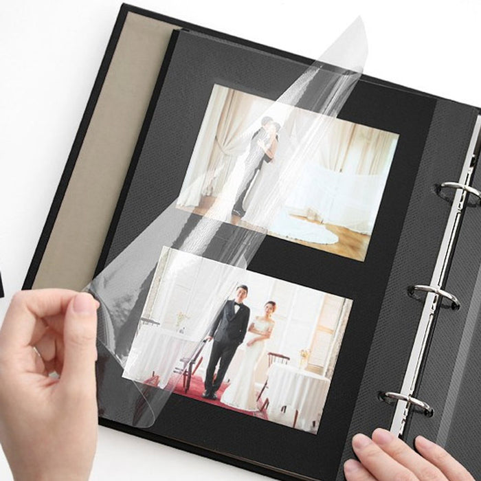 The Journal Shop - Open black scrapbook album showing two pages of printed photos and design inserts.