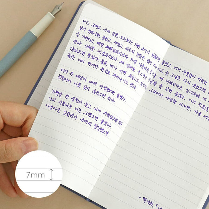 The Journal Shop - Iconic Solitude Handy Notebook open showing lined pages filled with purple fountain pen writing.