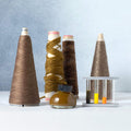 The Journal Shop - Kakimori Colour Specimen Ink bottles displayed with yarn cones and test tubes, inspired by textile ink 202.