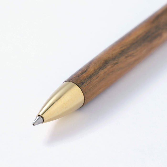 The Journal Shop - Close-up of the Kakimori Ballpoint Pen tip showing fine wood grain and smooth brass detailing.