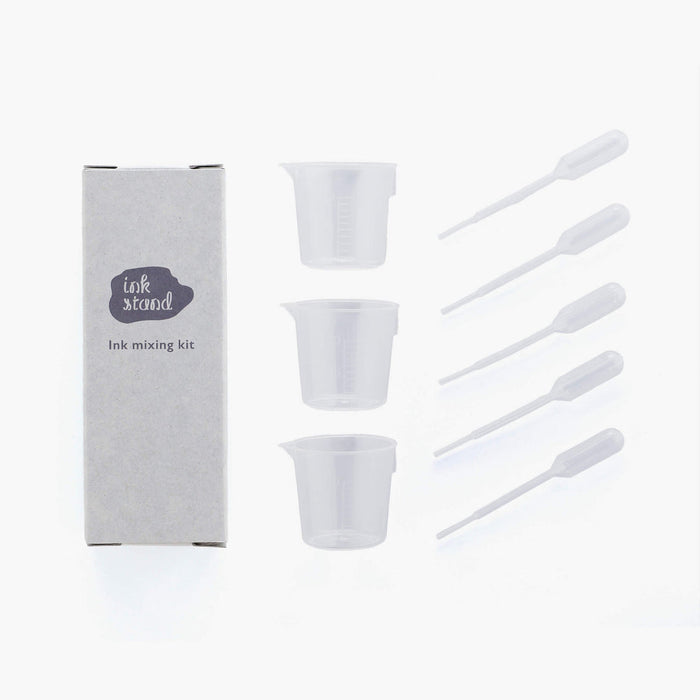 The Journal Shop - Kakimori Ink Mixing Kit with three clear measuring cups, three plastic droppers, and a grey storage box.
