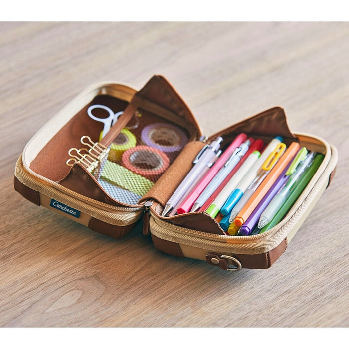 Interior compartments of the Beige Carchette carrying pouch organising stationery and small items.