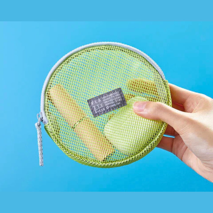 Yellow round Flatty Sheer transparent pouch held in hand showing mesh texture and zip closure.
