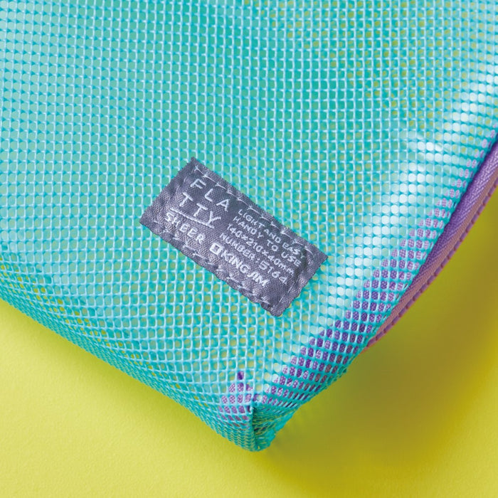 Close-up detail of the mesh texture and stitched label on a Flatty Sheer transparent pouch.