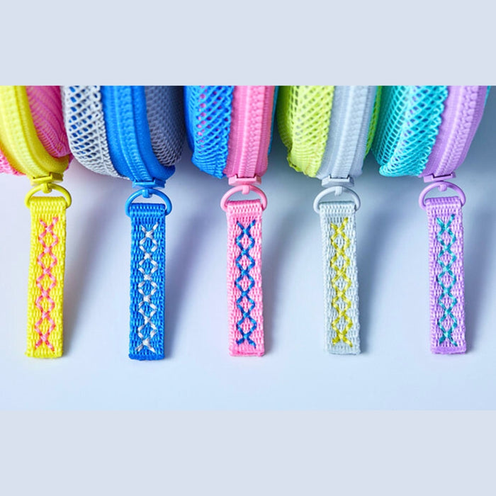 Flatty Sheer transparent pouch used to store colourful stationery items.