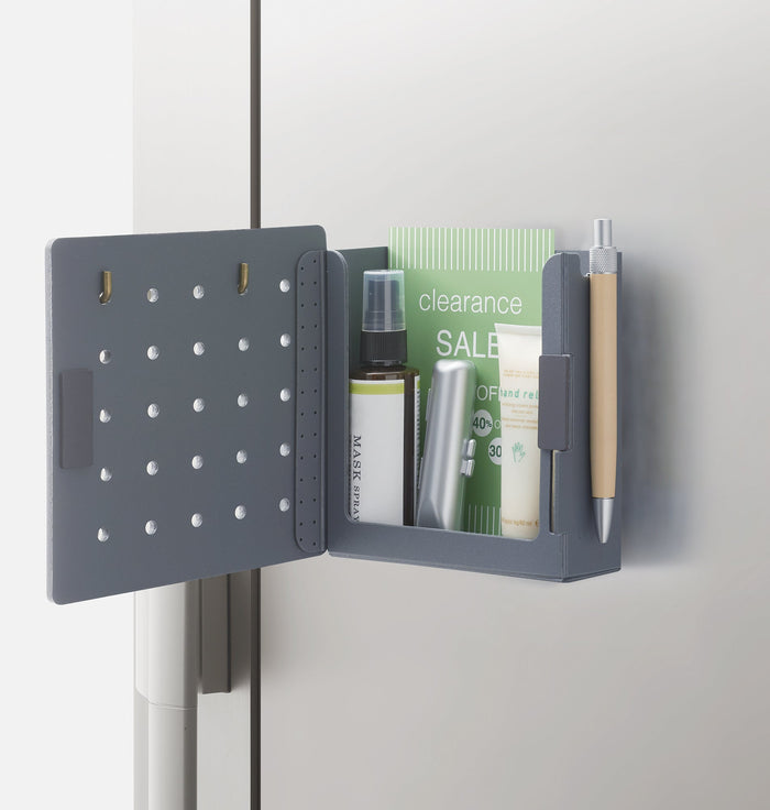 Harupeggy pegboard holding notebooks, pens and small containers.