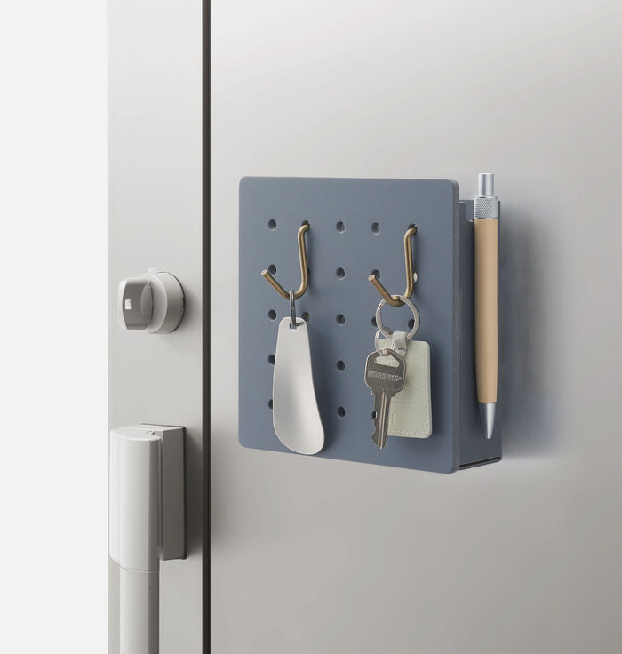 Harupeggy pegboard mounted on a door with organised stationery.