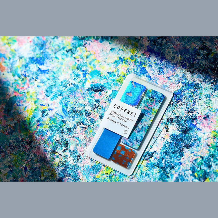 COFFRET cosmetic motif film stickers arranged decoratively on a textured surface.