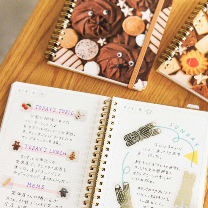 HITOTOKI comic size ring notebook opened with decorated journalling pages.