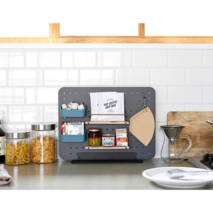 PEGGY black pegboard stand arranged on a desk with spices, condiments and small accessories.