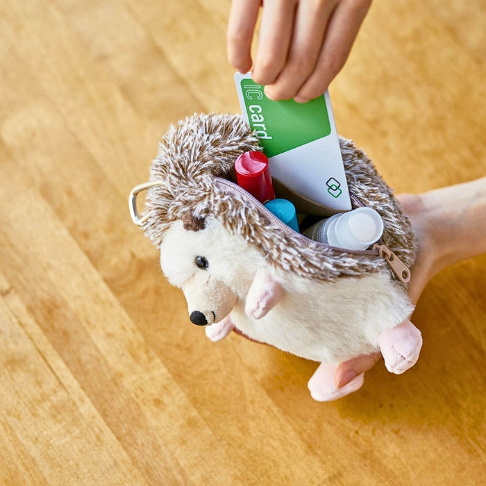 Pouzoo hedgehog animal design mini pouch held in hand, showing compact size.