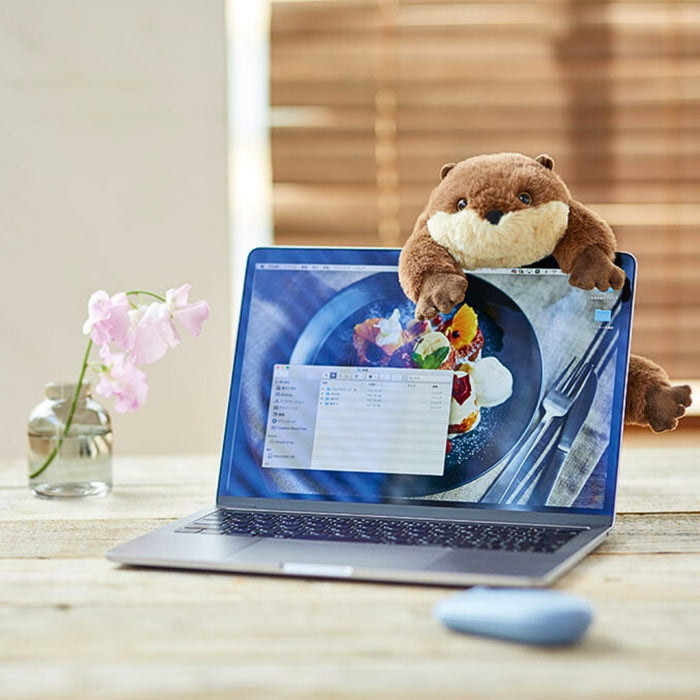 Pouzoo animal Otter design pen pouch styled on a laptop with stationery on a wooden desk.