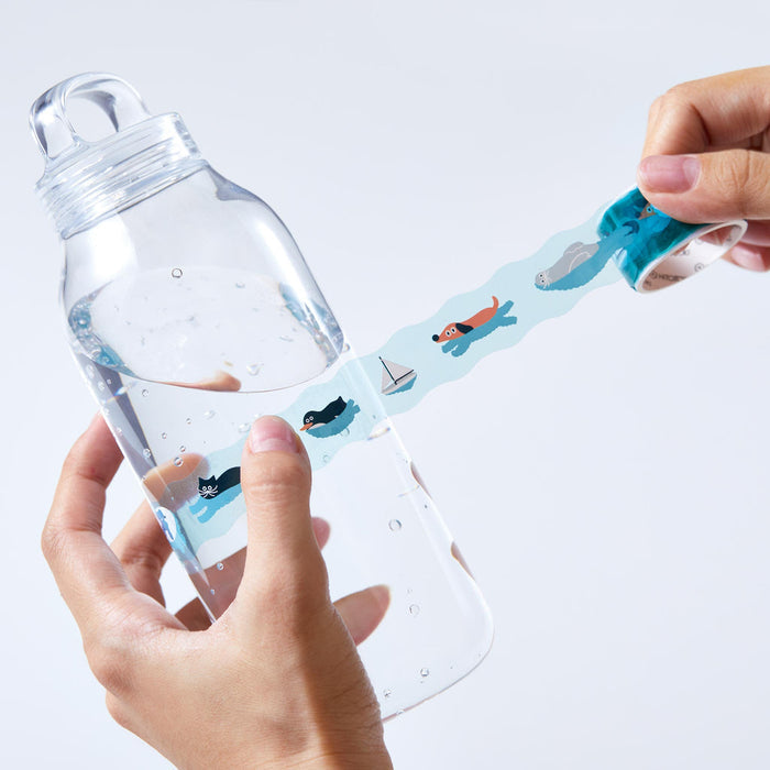 Decorating a clear bottle with SODA die-cut masking tape in pastel colours.