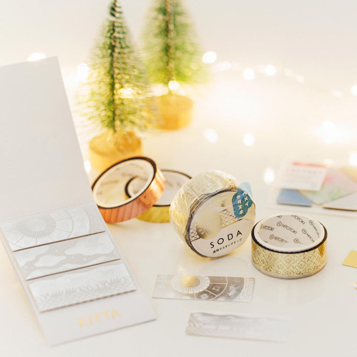 SODA foil and die-cut masking tape arranged with cards and stationery on a white desk.
