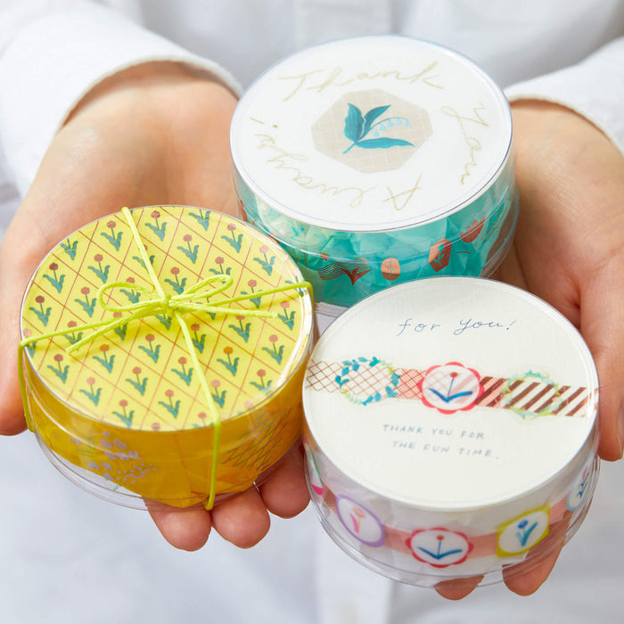 Hand holding multiple rolls of SODA foil masking tape in assorted designs.