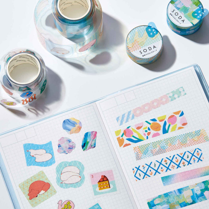 Assorted SODA glitter geometry masking tape rolls arranged together on a desk surface.