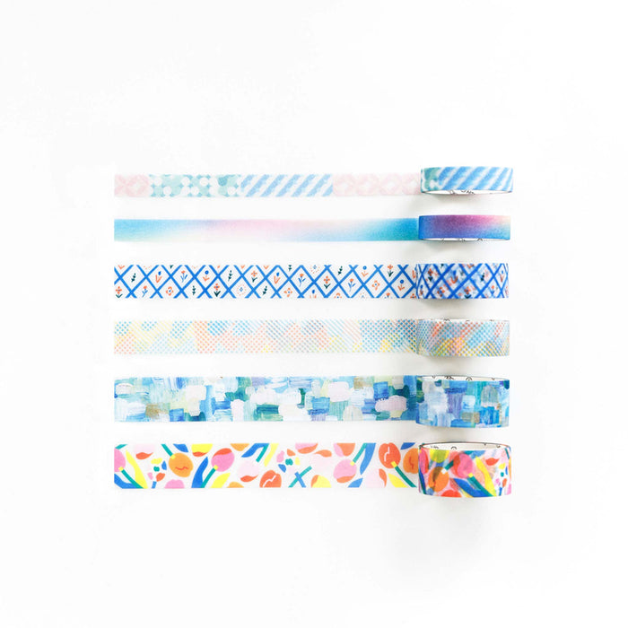 Multiple SODA glitter geometry masking tape rolls arranged together on a desk surface.