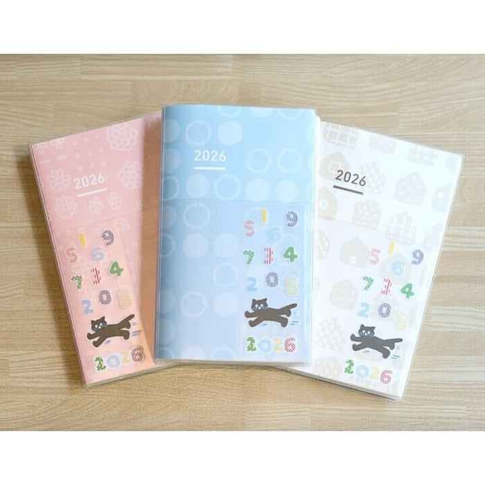 Covers of Kokuyo Jibun Techo DAYs 2026 A5 Slim Daily Planner SOUSOU Limited Edition in pastel pink, blue, and beige designs with playful cat motifs.