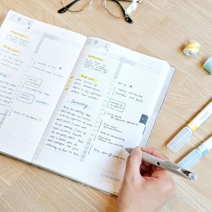 Person writing in Kokuyo Jibun Techo DAYs 2026 A5 Slim Daily Planner SOUSOU Limited Edition at a desk.