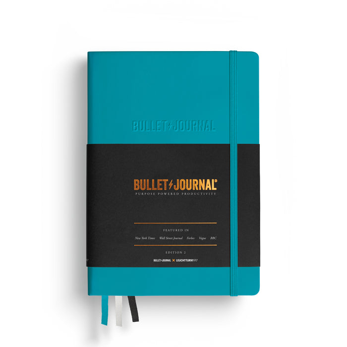 Front view of the Leuchtturm1917 Bullet Journal Edition notebook in Turquoise25 with elastic closure and ribbon markers.