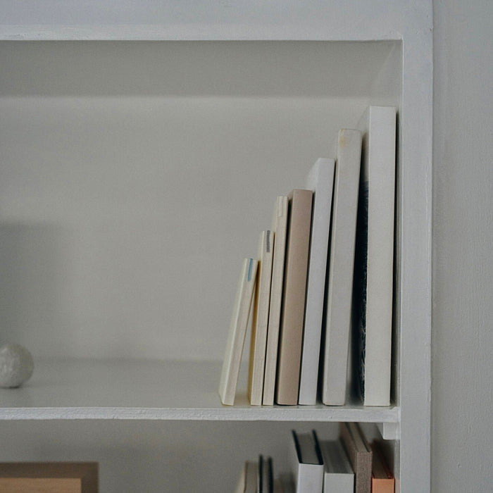 Midori MD Notebook A5 Plain displayed upright on shelf with other notebooks.