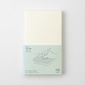 Midori MD Notebook Shinsho B6 Slim Grid with minimalist cream cover and subtle MD branding.