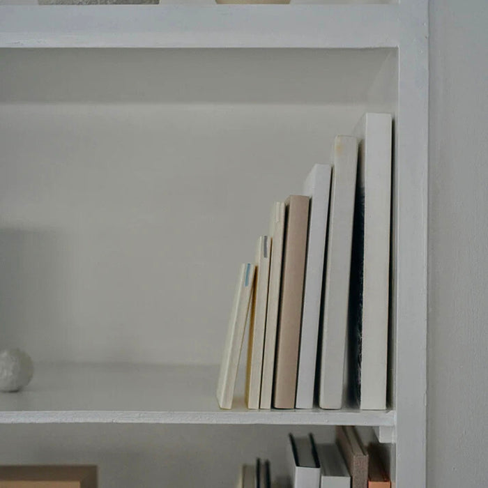 Midori MD Notebook Shinsho B6 Slim Grid displayed upright on shelf with other notebooks.