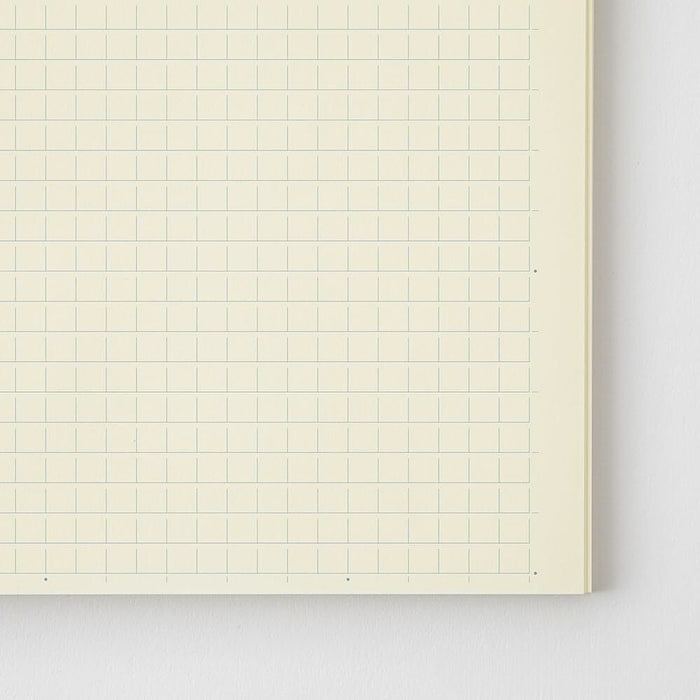 Close-up of Midori MD Notebook Shinsho B6 Slim Grid page showing subtle square grid pattern.