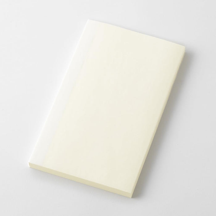 Midori MD Notebook Shinsho B6 Slim Lined placed at an angle highlighting slim paperback format.