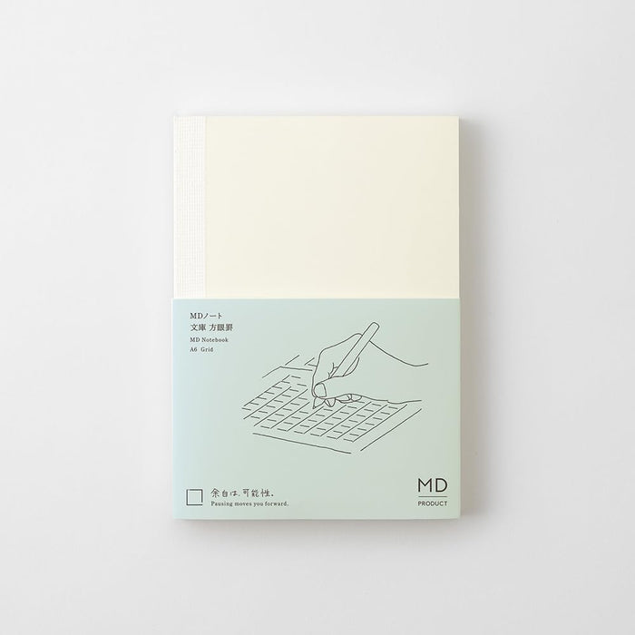 Midori MD Notebook Paperback A6 Grid with minimalist cream cover and subtle MD branding.