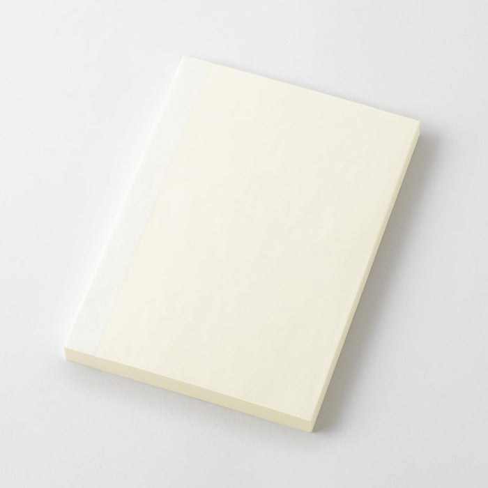 Midori MD Notebook Paperback A6 Plain placed at an angle highlighting slim paperback design.