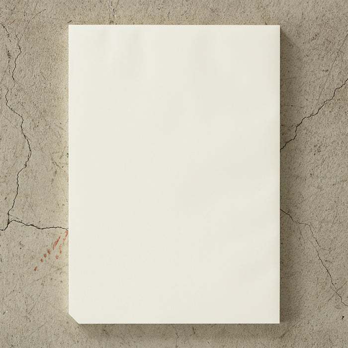 Close-up of Midori MD Paper Desk Notepad A4 with clean, blank pages and a subtle cream tone.