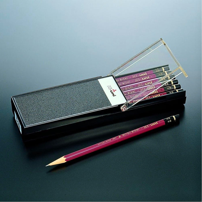 Mitsubishi Hi-Uni pencil case with one maroon pencil placed alongside on dark background.
