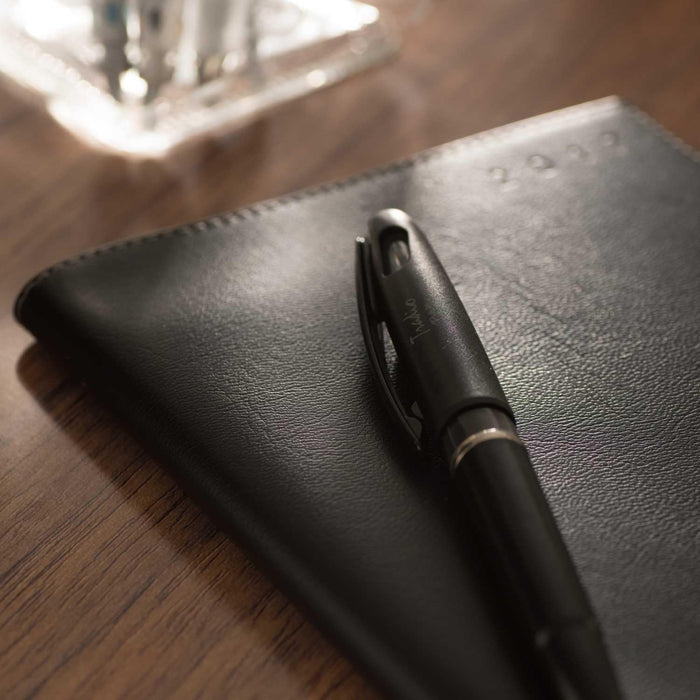Pentel Tradio pen resting elegantly on a leather notebook, perfect for professionals and creatives.