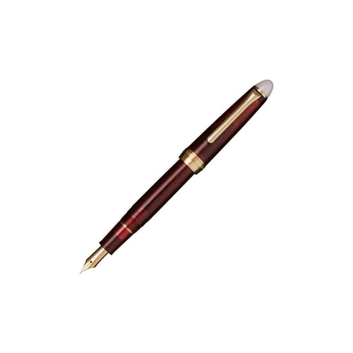 Sailor Shikiori Night Burn fountain pen with deep burgundy resin barrel and gold trim.