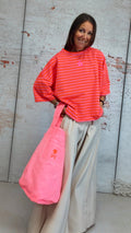 Sudadera "orange juice" rosa flúor de mangas abullonadas