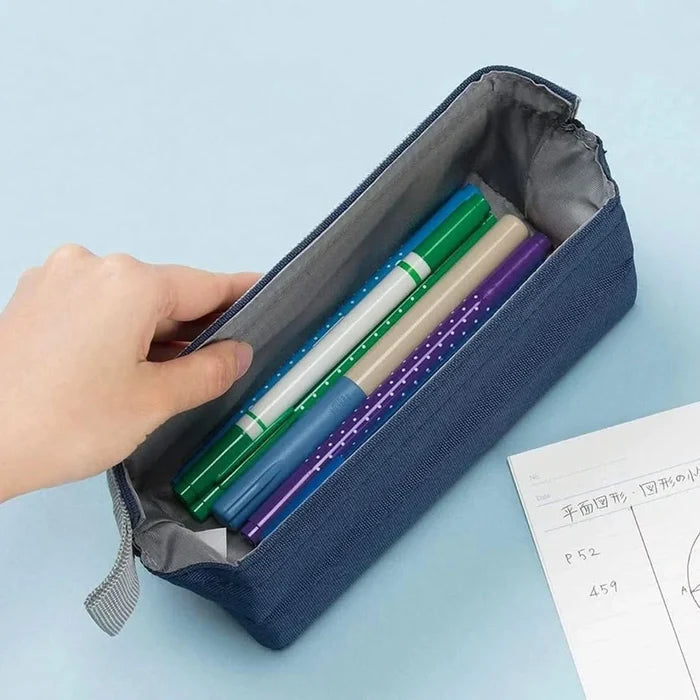 Sun-Star Arkno portable pen pouch in navy opened, filled with colourful pens, placed on a desk with notebook.