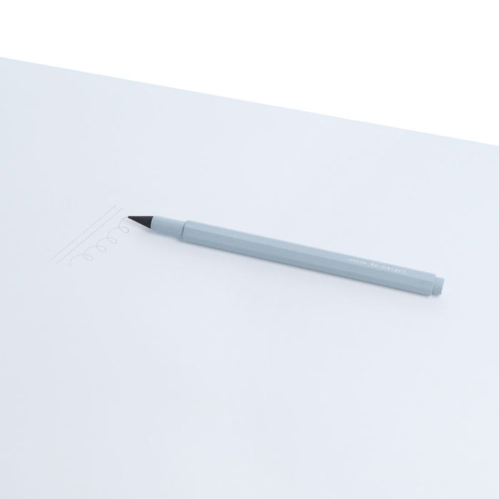 Sun-Star Re:metacil metal pencil in use, shown writing fine grey lines and a swirl on white paper.