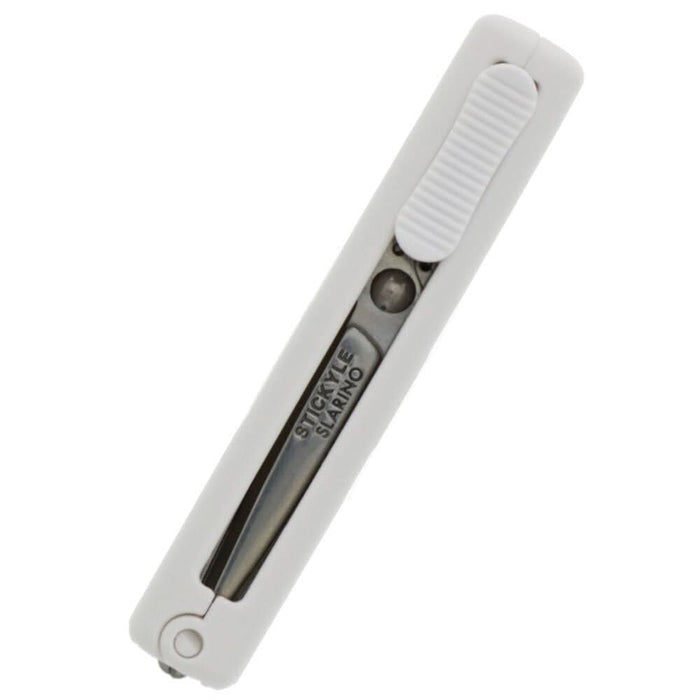 Close-up of Sun-Star Slarino Stickyle white retractable scissors showing the blade partially retracted.