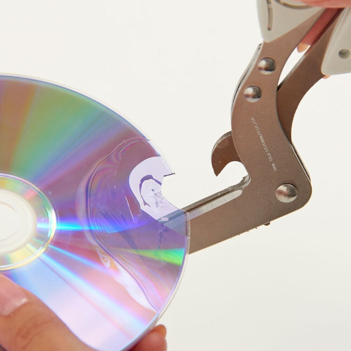 Sun-Star Triple Blade Shredder Scissors cutting through a CD, demonstrating its shredding power.
