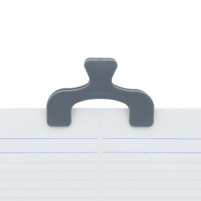 Forest Fog Sun-Star Ukanmuri Petite Clip attached to the top of an open notebook, holding the pages flat.