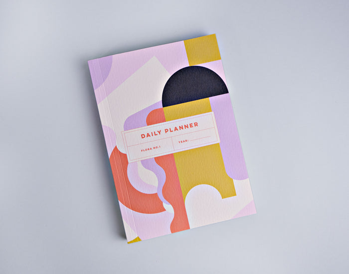 The Completist Flora Undated Daily Planner open to show its daily layout.