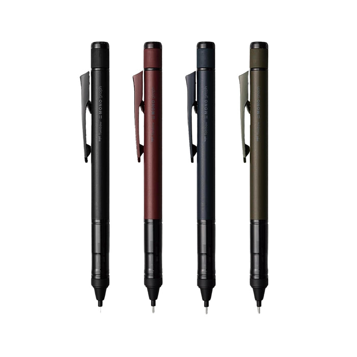 The Journal Shop - Four Tombow MONO Graph Black Edition mechanical pencils in matte black, navy, red, and olive green, displayed upright on a white background.