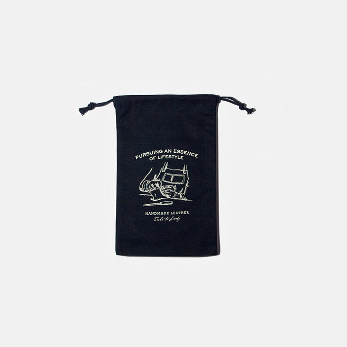 Front view of the black Tools To Live By canvas dust bag with printed design.