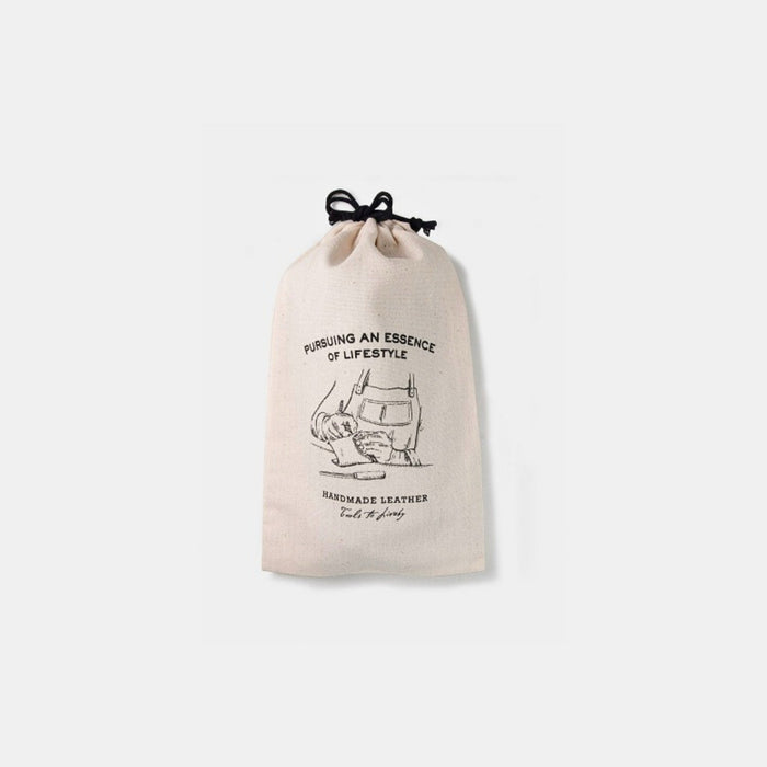 White canvas Tools To Live By all-purpose dust bag with drawstring closure.