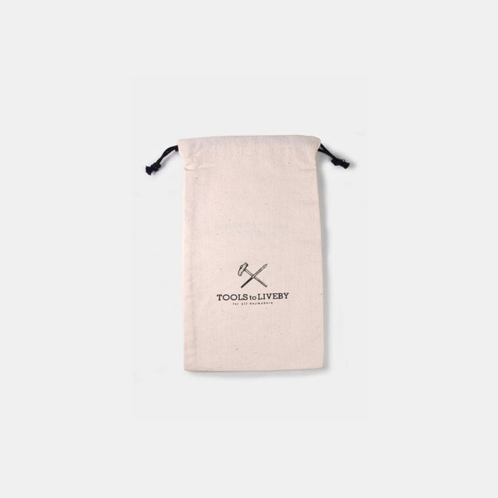 Rear view of natural canvas Tools To Live By dust bag showing printed logo design.