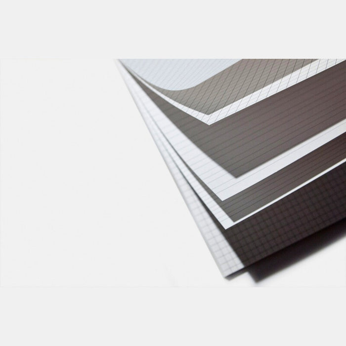 Stack of plain practice pages showing smooth paper edges inside the calligraphy notebook.